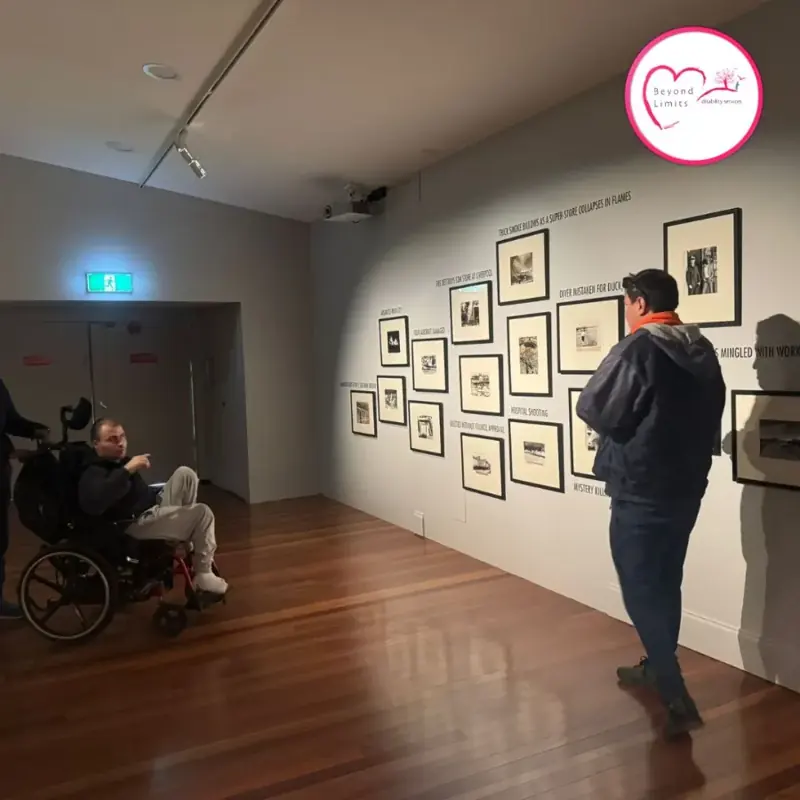 Participants looking at framed artworks during an art gallery visit